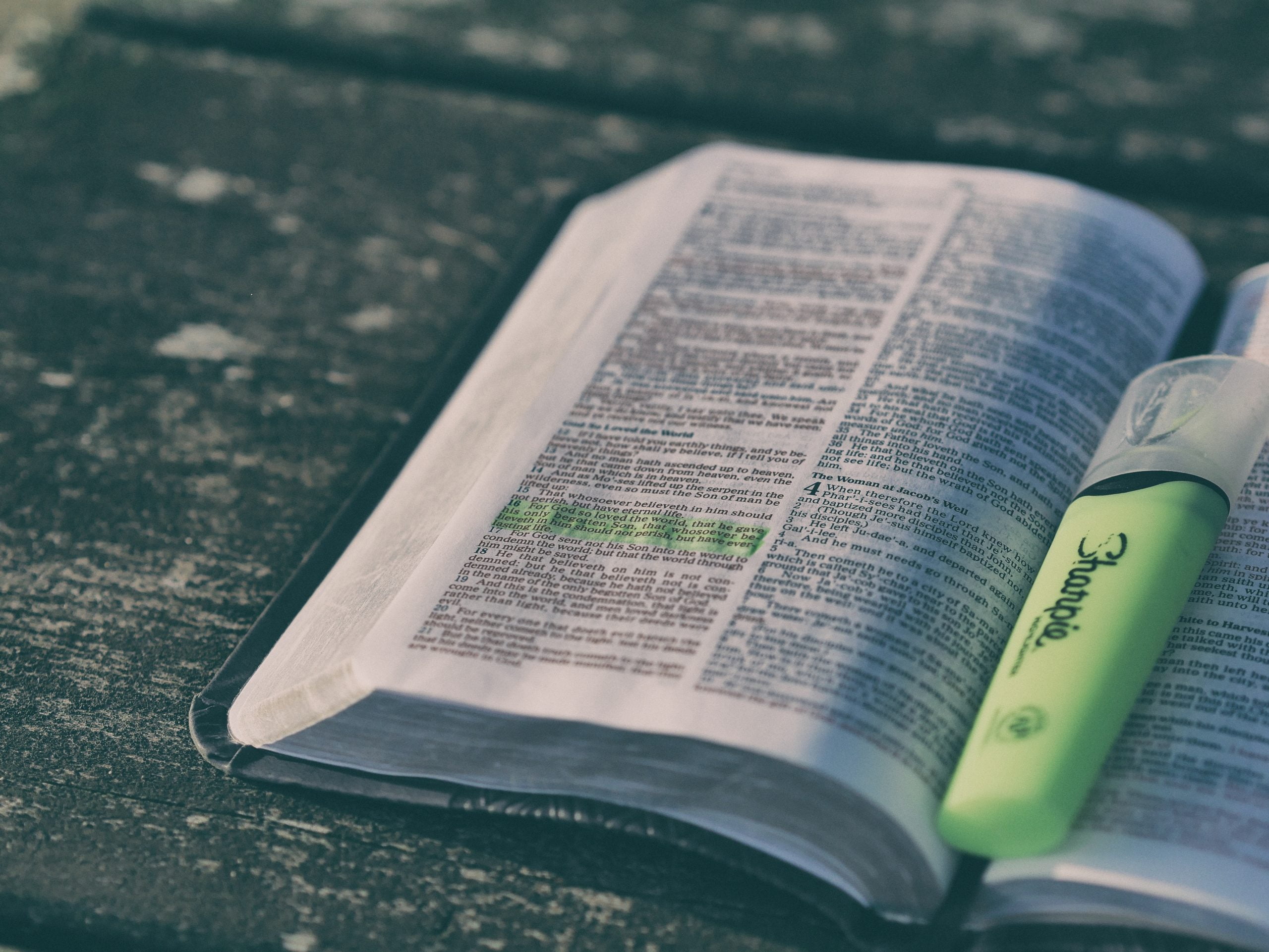 an open Bible with a book marker in it