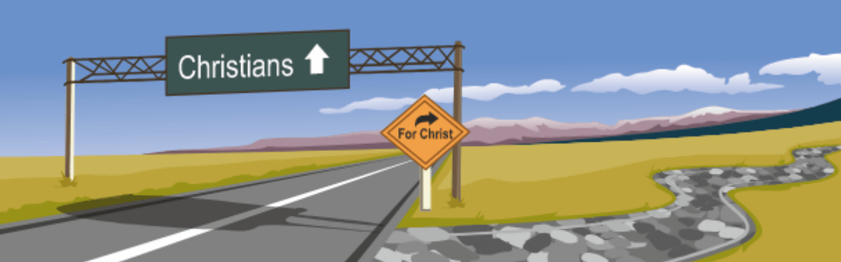 wide road with sign overhead reading for christ